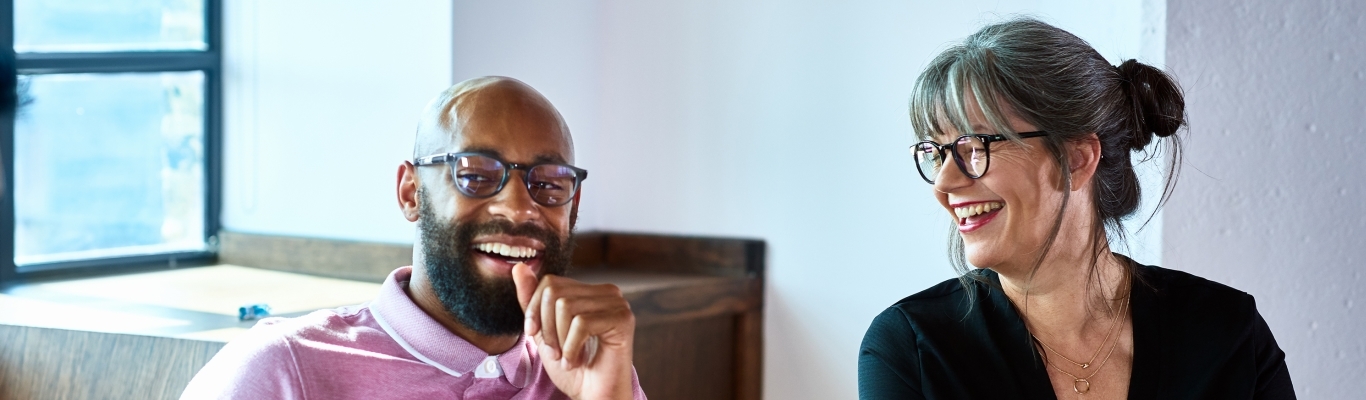 Two coworkers laughing