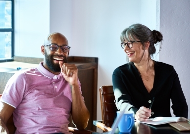 Two coworkers laughing