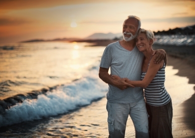 Senior Couple Hugging on Beach