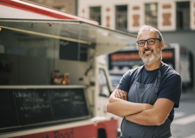 Man standing by his food truck